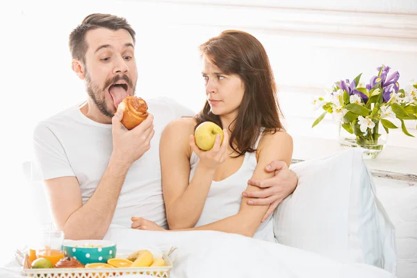 Relaxed Couple in Bed in bedroom at home