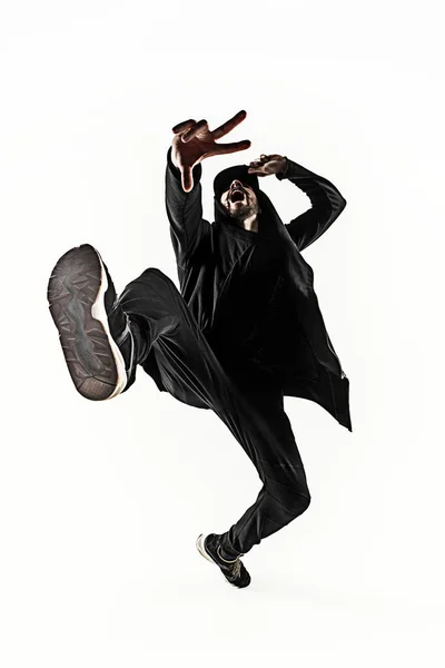 Die Silhouette eines männlichen Breakdancers, der auf weißem Hintergrund tanzt — Stockfoto