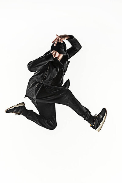 The silhouette of one hip hop male break dancer dancing on white background