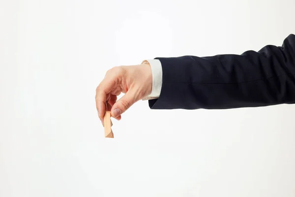 Mans hands holding wooden puzzle. — Stock Photo, Image