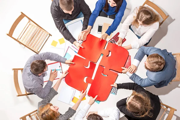 Team sitting behind desk, checking reports, talking. Top View — Stock Photo, Image