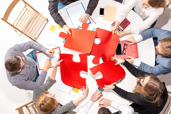 Team sitting behind desk, checking reports, talking. Top View — Stock Photo, Image