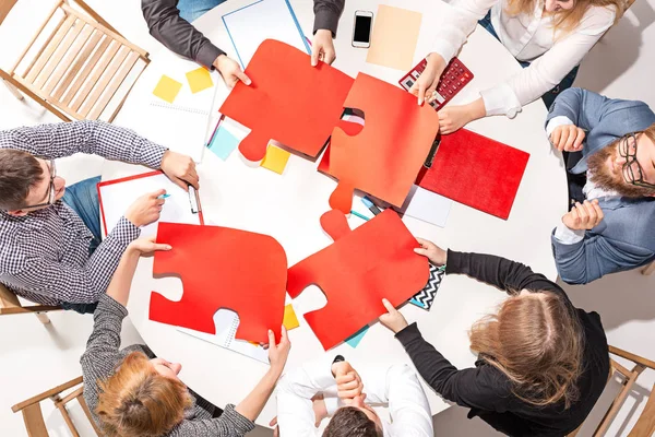 Team sitting behind desk, checking reports, talking. Top View — Stock Photo, Image