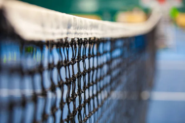 Close up view of tennis court through the net — Stock Photo, Image