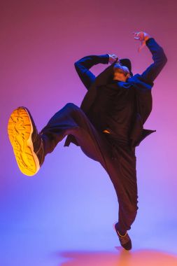 Renkli arka plan üzerinde bir hip hop erkek break dansçı silüeti