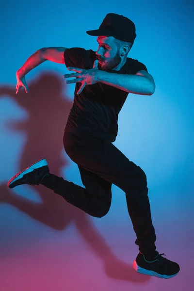 在彩色背景上跳舞的一个嘻哈男打破舞者的剪影 — 图库照片