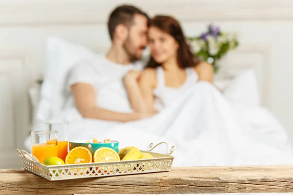 Relaxed Couple in Bed in bedroom at home