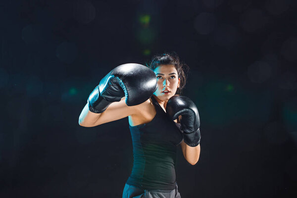 The female boxer training at sport club