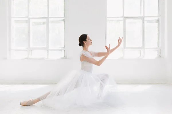 Young and incredibly beautiful ballerina is posing and dancing in a white studio — Stock Photo, Image