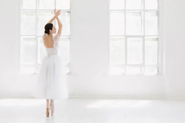 Young and incredibly beautiful ballerina is posing and dancing in a white studio — Stock Photo, Image