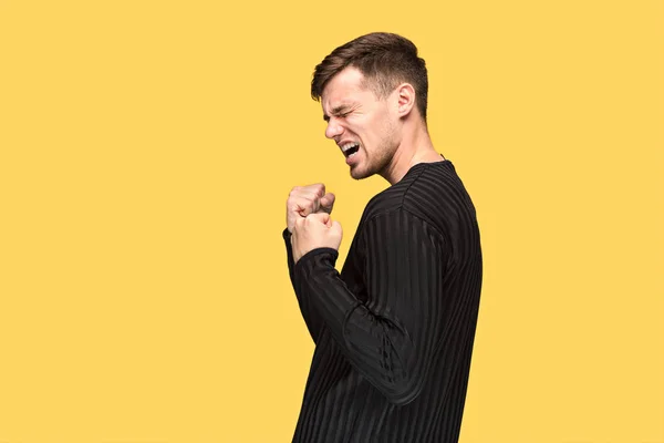 The young man with a raised fist — Stock Photo, Image