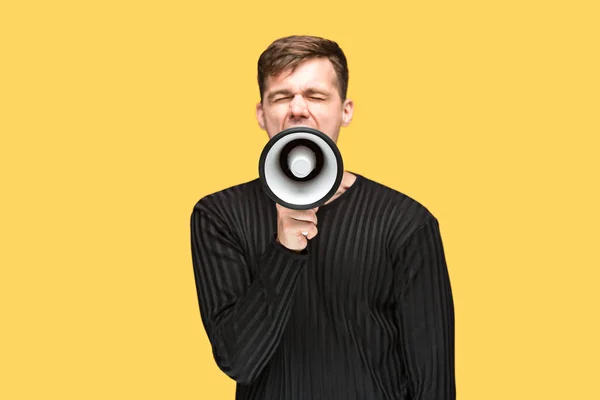 The young man holding a megaphone — Stock Photo, Image