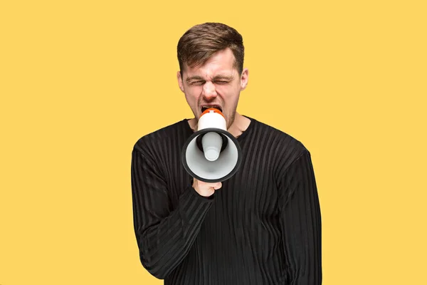 The young man holding a megaphone — Stock Photo, Image