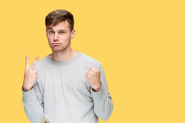 The young man with a raised fist — Stock Photo, Image