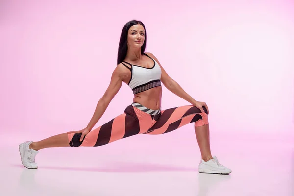 The woman training against pink studio — Stock Photo, Image