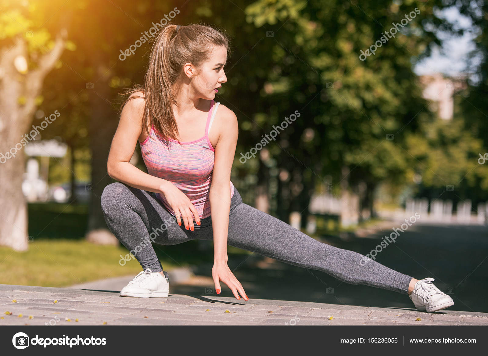 Fit fitness woman doing stretching exercises outdoors at park Stock Photo  by ©vova130555@gmail.com 156236056