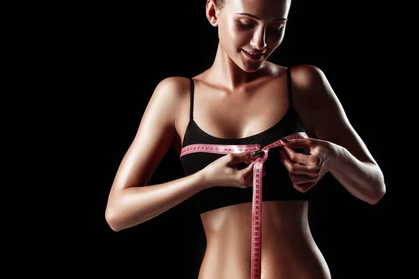 The fit woman measuring perfect shape of beautiful body. Healthy lifestyles concept — Stock Photo, Image