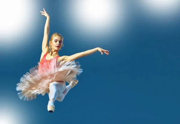 Piękne kobiece baletnica na szarym tle. Baletnica nosi różowe tutu i pointe buty. — Zdjęcie stockowe