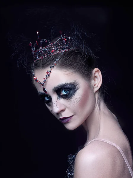 Portrait of the ballerina in the role of a black swan on black background — Stock Photo, Image