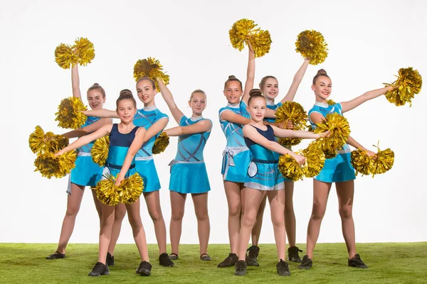 The group of teen cheerleaders posing at white studio