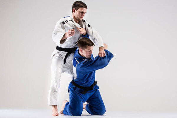 The two judokas fighters fighting men