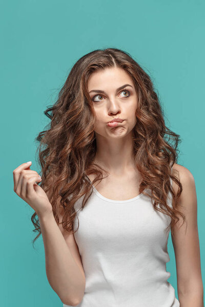 The young womans portrait with thoughtful emotions