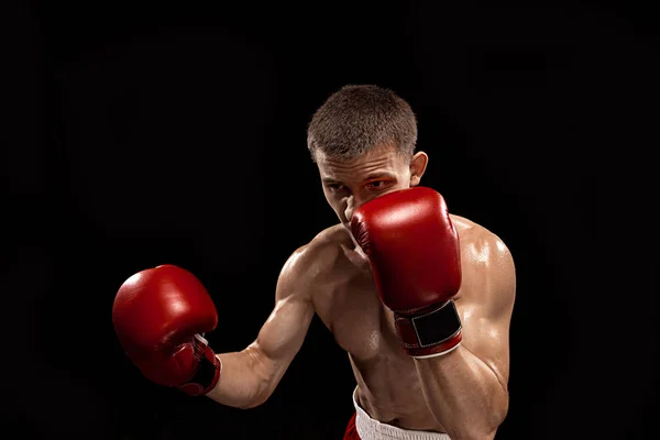 Male boxer boxing with dramatic edgy lighting in a dark studio — Stock Photo, Image