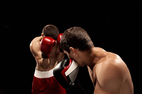 Two professional boxer boxing on black background, — Stock Photo, Image