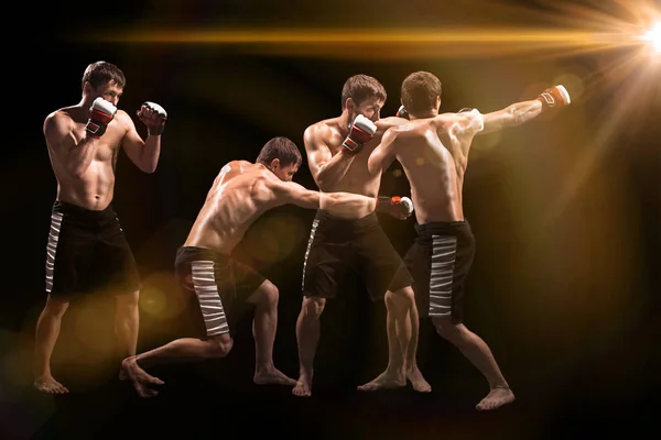 Male boxer boxing in punching bag with dramatic edgy lighting in a dark studio — Stock Photo, Image