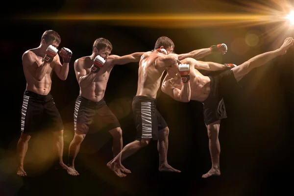 Male boxer boxing in punching bag with dramatic edgy lighting in a dark studio — Stock Photo, Image