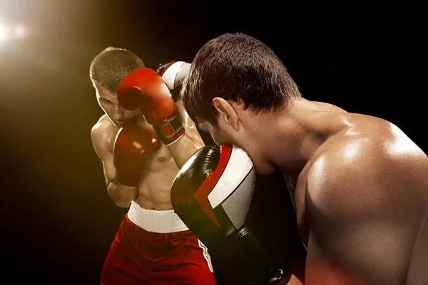 Two professional boxer boxing on black background, — Stock Photo, Image