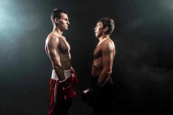 Two professional boxer standing on black smoky background, — Stock Photo, Image