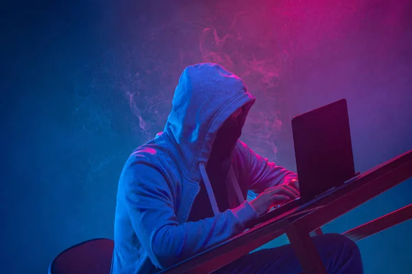 Hooded dator hacker stjäla information med bärbar dator — Stockfoto