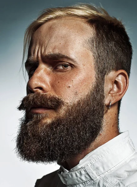 Portrait of hipster bearded mans side face.