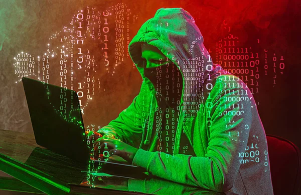 Hooded computer hacker stealing information with laptop — Stock Photo, Image