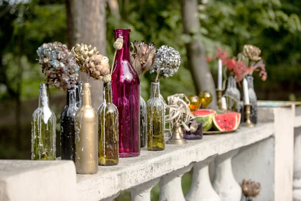 Burning candle in the vintage black bottle — Stock Photo, Image