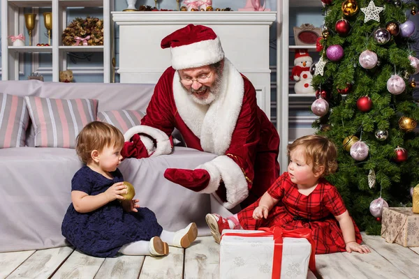 As duas meninas com Papai Noel no estúdio com decorações de Natal — Fotografia de Stock