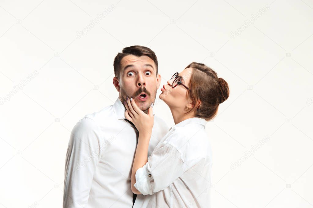The business man and woman communicating on a gray background