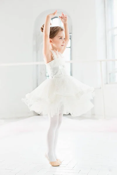 Маленькая балерина в пачке. Очаровательный детский танец классического балета в белой студии . — стоковое фото