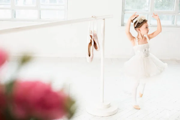 Little ballerina girl in a tutu. Adorable child dancing classical ballet in a white studio. — Stock Photo, Image