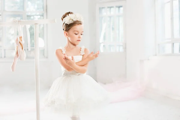 Little ballerina girl in a tutu. Adorable child dancing classical ballet in a white studio. — Stock Photo, Image