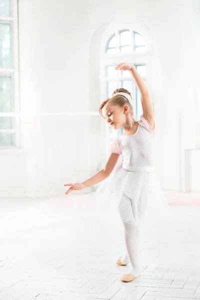 Pequeña bailarina en un tutú. Adorable ballet clásico de danza infantil en un estudio blanco . — Foto de Stock