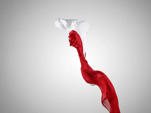 Elegante tessuto rosso e bianco trasparente liscio separato su sfondo grigio . — Foto Stock