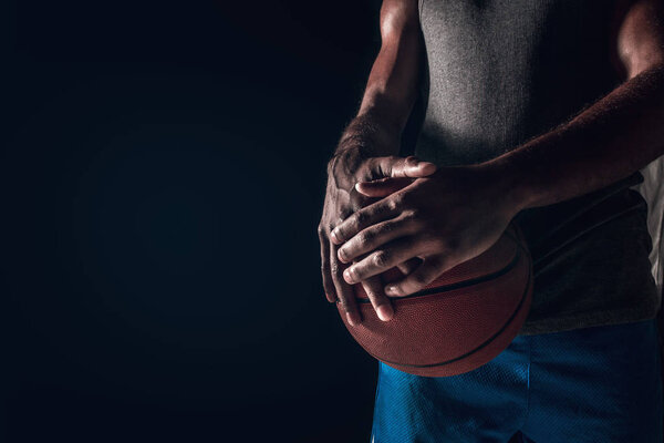 The hands of a basketball player with ball