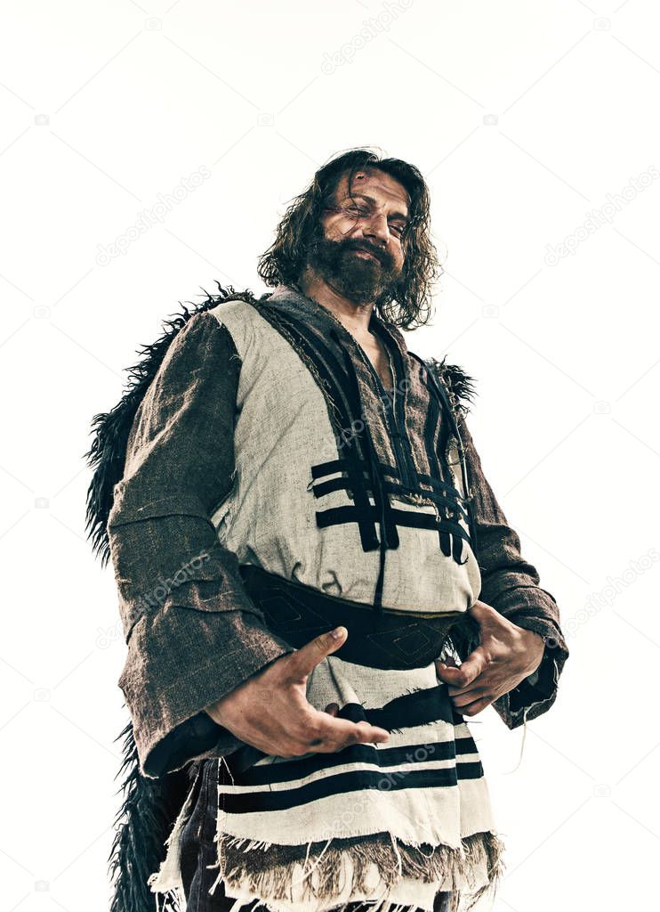 Portrait of a brutal bald-headed viking in a battle mail posing against a white background.