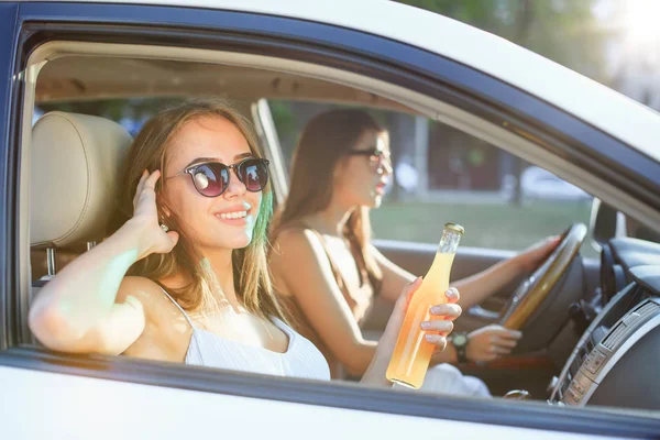 Las jóvenes en el coche sonriendo — Foto de Stock