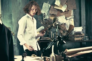 Yazar iş başında. Masanın ayakta ve zihninde bir şey yapma yakışıklı genç yazar