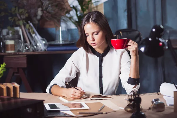 Joven hermosa mujer trabajando con una taza de café — Foto de Stock