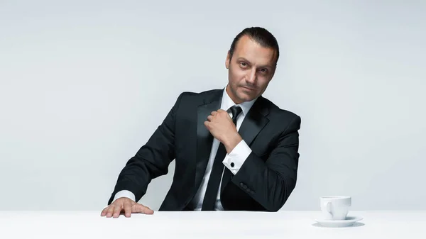 O homem atraente em terno preto no fundo branco — Fotografia de Stock