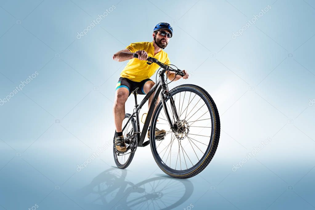 The bicyclist on gray, studio shot.